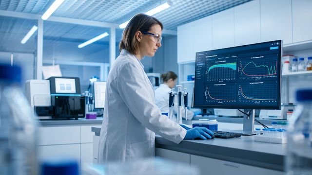 AI-generated image of a scientist reviewing sequencing quality score profiles on a laboratory monitor. 