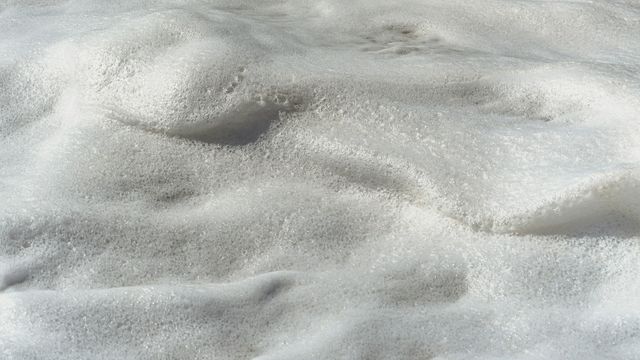 White foam forms soft textures. 