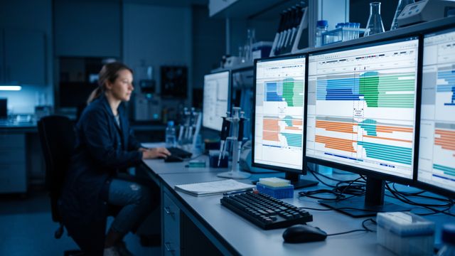 AI-generated image of a researcher reviewing structural variant alignment data on a bioinformatics workstation. 