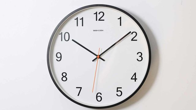 A round analog wall clock showing the time. 