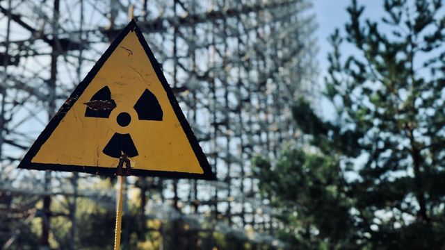 Radiation warning sign in a forested area. 