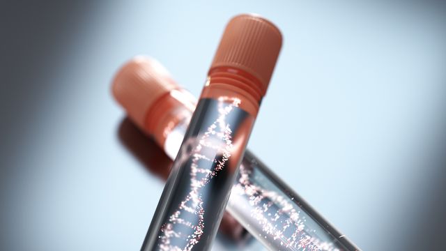 Glowing DNA double helices inside test tubes with orange lids. 