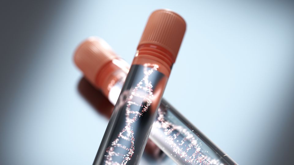 Glowing DNA double helices inside test tubes with orange lids.