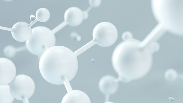 A digital illustration of molecular structures floating around in empty space. 