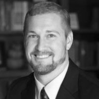 A greyscale headshot of Daniel DeBord