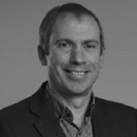 A greyscale headshot of Paul Royle