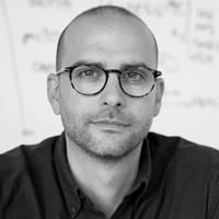 A greyscale headshot of Justin Eyquem