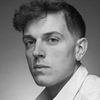 A greyscale headshot of Andrew Mancini