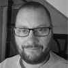 A greyscale headshot of Richard Cuthbert