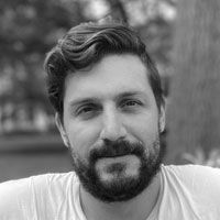 A greyscale headshot of Carlos Carmona-Fontaine