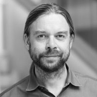 A greyscale headshot of Jack Gilbert