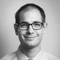 A greyscale headshot of Theo Roth