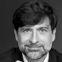 A greyscale headshot of Istvan Petak