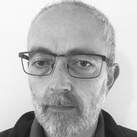 Head shot of Adam Corner