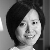 A black and white image of Dr. Pei, smiling at the camera. She has a black shoulder-length bob haircut and is wearing a white top.