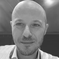 A greyscale headshot of Matteo Marchesini