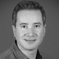 Headshot of Dr. Cesar Canales in greyscale.