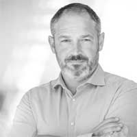 Black and white headshot of Claudio Panzarella.