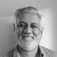 Black and white headshot of Dr. Gargey Yagnik. Gargey is smiling at the camera.