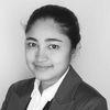 A grayscale image of Hansana Gunathilaka, smiling slightly at the camera.