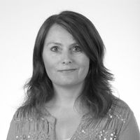 Headshot of Berit Reed in greyscale.