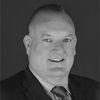Headshot of Dr. Dominic Gostick in greyscale.