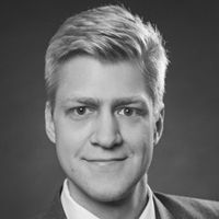 Headshot of Dr. Simon Sumer in greyscale.