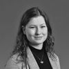 A grayscale image of Annika Wittich, smiling slightly at the camera.