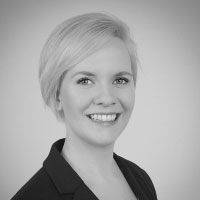 A grayscale image of Dr. Maren Feist, smiling at the camera.