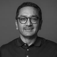 A greyscale headshot of Sonjoy Mukerjee