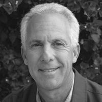 Greyscale Headshot of Adam Goldstein