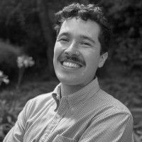 Black and white headshot of Nick Scales smiling