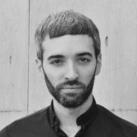 A greyscale headshot of Marco Reggiani
