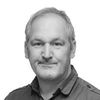 Greyscale headshot of Dr John Heal
